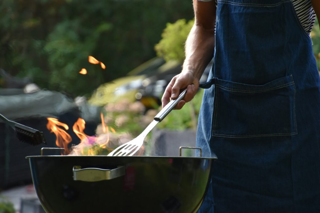 Man at a grill with flames